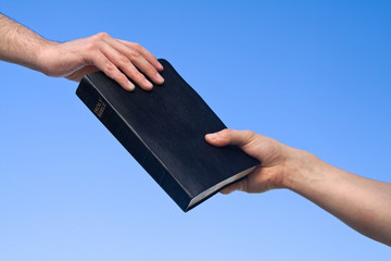 Hand Giving Bible