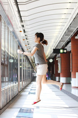 Running of a woman in rush hours on train station