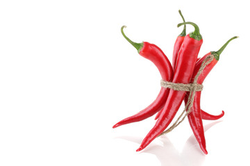 Red hot chili peppers tied with rope isolated on white