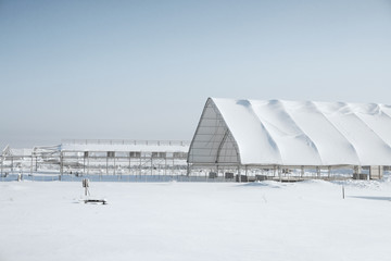 Unfinished structure with a shed in winter