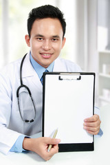 doctor showing blank clipboard