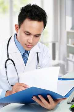 medical doctor reading a report