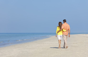Fototapeta na wymiar Couple Walking on An Empty Beach