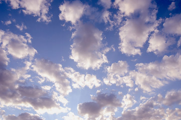 cloudy blue spring sky sun-lit background
