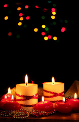Beautiful candles on wooden table on bright background