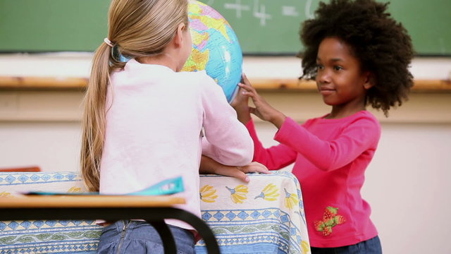 Classmates looking at a globe