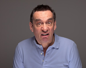 Obraz premium Middle Age Man Pulling Funny Grimace Face