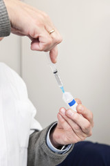 Doctor Filling Syringe For Vaccination