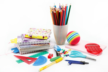School supplies: notebook, pens, pencils on a white background.