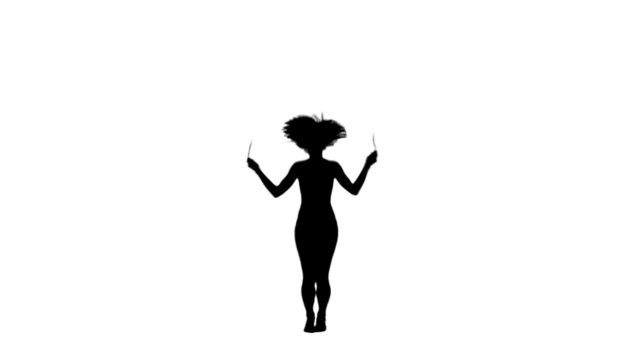 Silhouette woman exercising with a skipping rope
