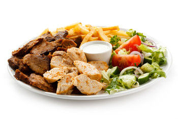 Grilled meat with French fries and vegetables