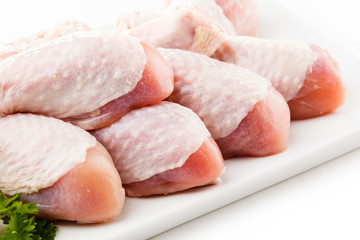 Raw chicken legs on white background