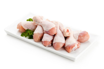 Raw chicken legs on white background