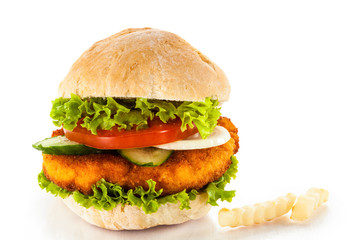 Big hamburger, French fries and vegetables on white background
