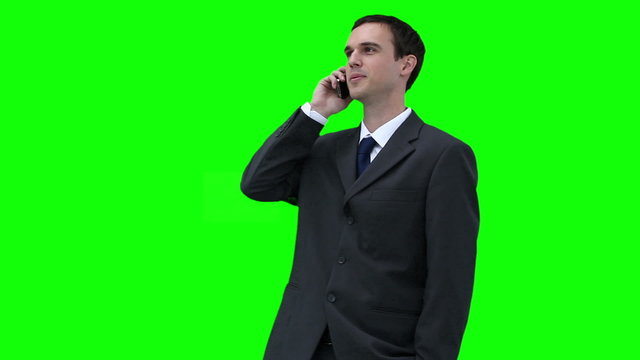 Businessman looking around while talking on a phone