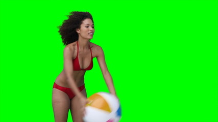 A woman throws a beachball off screen multiple times - Powered by Adobe