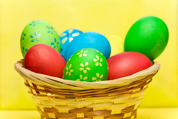 Fototapeta na wymiar Colored eggs in basket