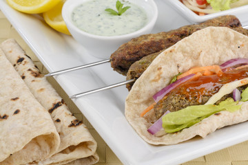 Seekh Kebab -Minced meat kebab with chili sauce, raita & chapati