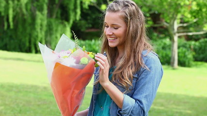 Joyful woman receiving a bunch of flowers - Powered by Adobe