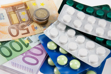 closeup pills and money concept isolated on white background