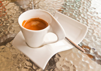 Coffee cup on glass table
