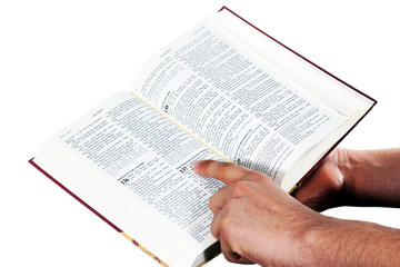 Praying hand hold an open bible