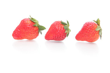 Three strawberries and reflection