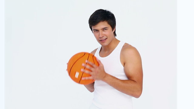 Man spins a basketball on his figer