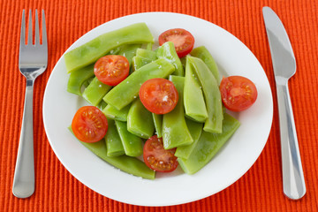 salad green beans and tomato on the plate