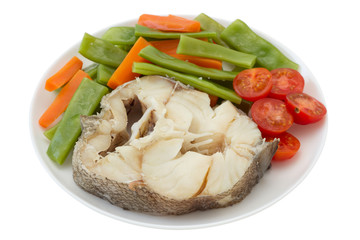 boiled fish with vegetables on the plate