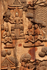 Thai art sculpture on wood door in Thai temple .