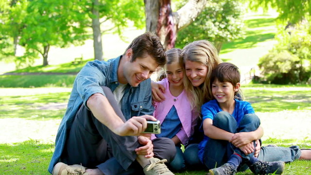 Family watching picture on a digital camera