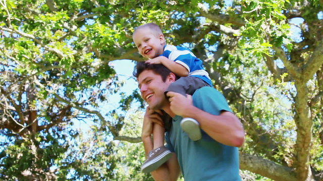 Man putting his son on his shoulders