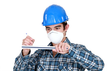 A manual worker with a ruler.