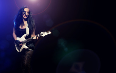 fashion girl with guitar playing hard rock