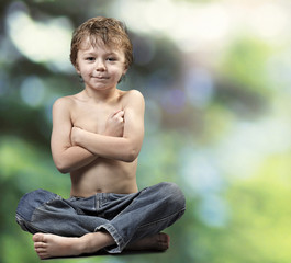 Obraz premium Young boy Buddha on green forest background