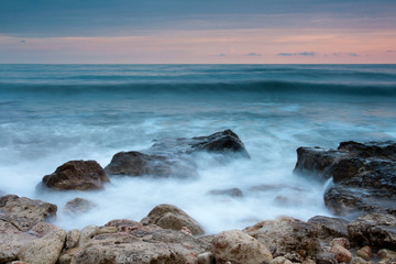 Fototapeta na wymiar Beautiful rocky sea beach at the sunset
