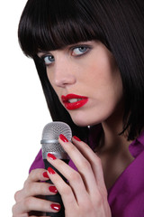 female singer caressing a micro