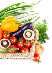 fresh vegetables with leaves in the basket isolated on white
