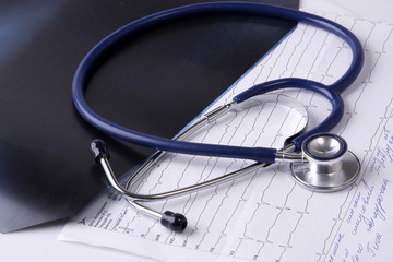 A medical stethoscope on documents, closeup