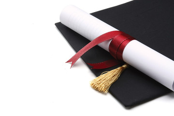 A university diploma with a red ribbon isolated on white
