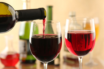 Pouring red wine into glasses