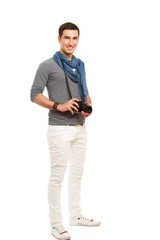 Fototapeta premium A full-length portrait of a young photographer with a camera