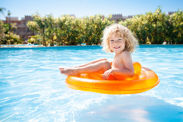 Happy kid swimming in pool