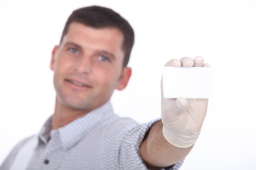 man holding out blank business card