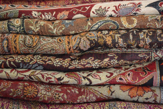 Pile Of Folded Colour Fabrics And Shawls