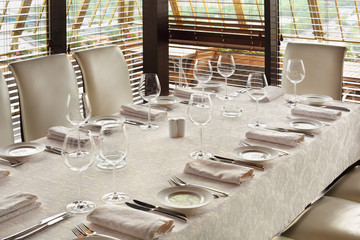 beautiful serving at table with tablecloth in empty restaurant