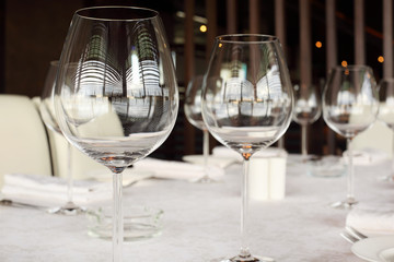 glasses at table with white tablecloth in restaurant