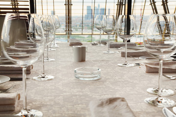 glasses at table with white tablecloth in restaurant