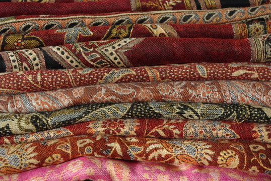 Pile Of Folded Colour Fabrics And Shawls